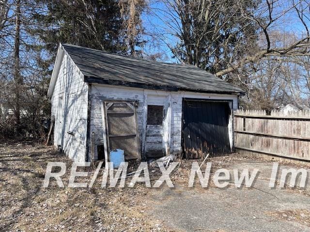 view of outbuilding featuring an outbuilding and fence