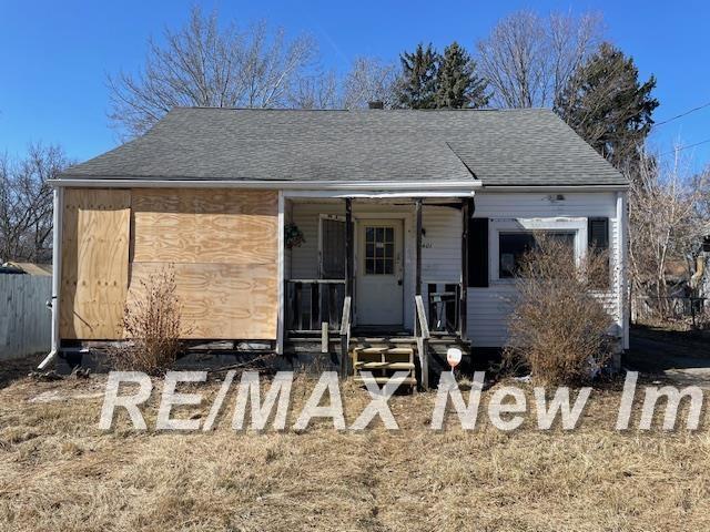 view of front of property featuring roof with shingles and covered porch