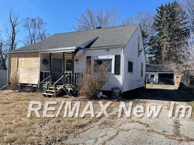 bungalow featuring roof with shingles and a porch