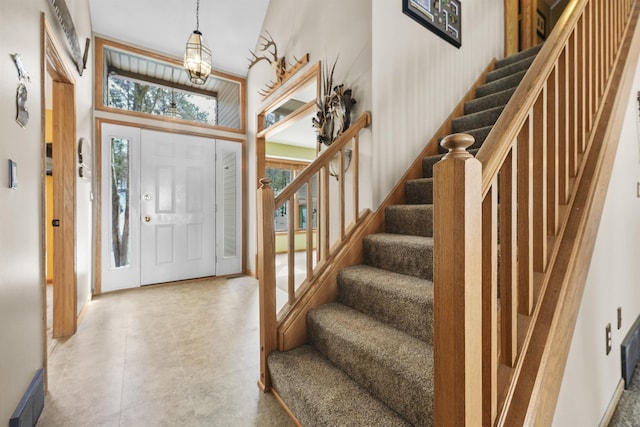 entryway with stairway, a high ceiling, and visible vents