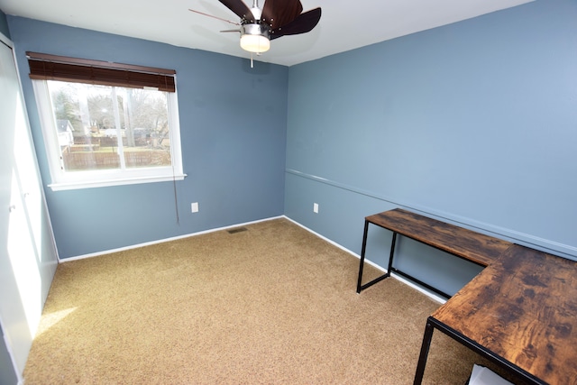 interior space featuring visible vents, carpet floors, baseboards, and ceiling fan