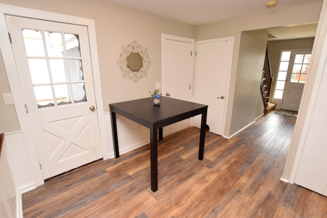 entrance foyer featuring stairway, baseboards, and wood finished floors