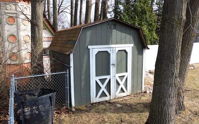 view of shed featuring fence