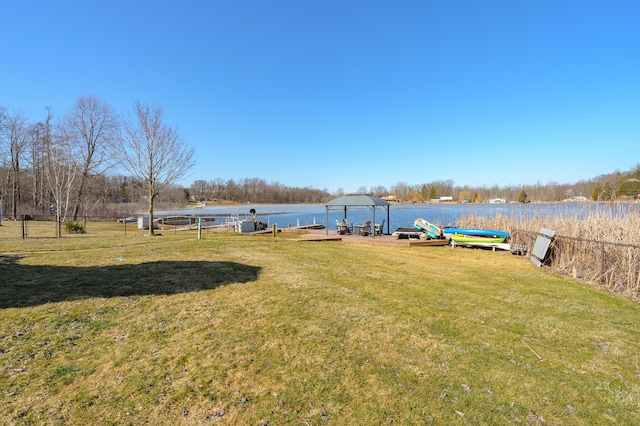 view of yard with a water view and a boat dock