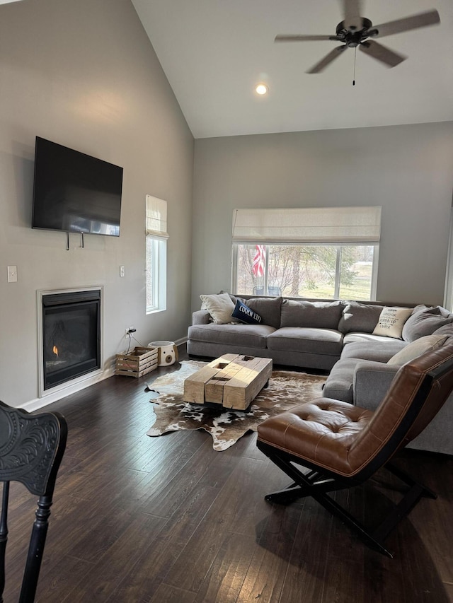 living room featuring ceiling fan, recessed lighting, a glass covered fireplace, high vaulted ceiling, and wood-type flooring