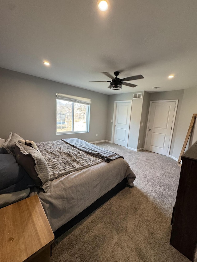 carpeted bedroom featuring a ceiling fan, recessed lighting, baseboards, and visible vents