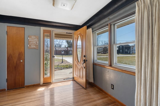 entryway featuring hardwood / wood-style flooring and baseboards