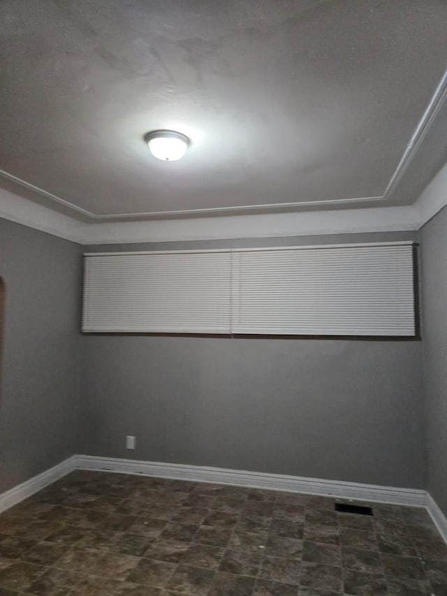 unfurnished room with visible vents and baseboards