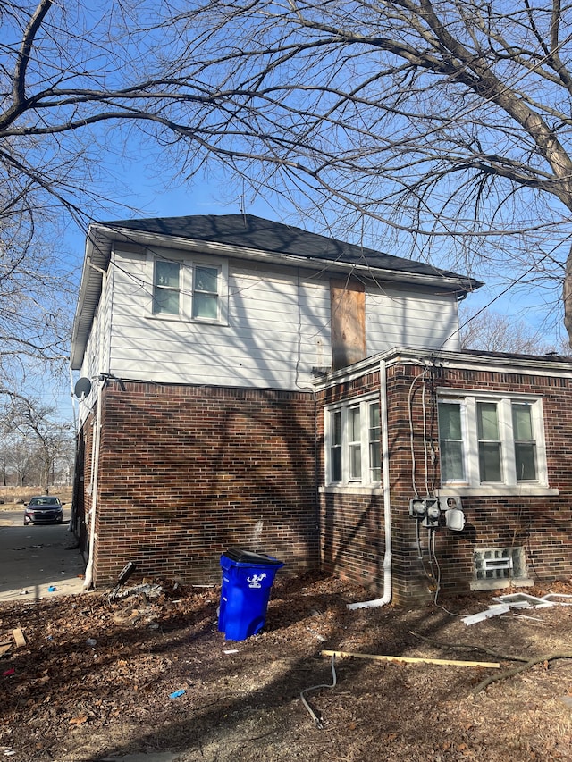 view of property exterior with brick siding