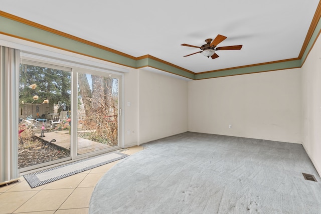 empty room with ceiling fan, light tile patterned flooring, visible vents, and ornamental molding