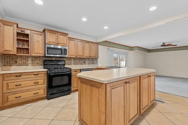 kitchen with light tile patterned flooring, a sink, stainless steel appliances, light countertops, and crown molding