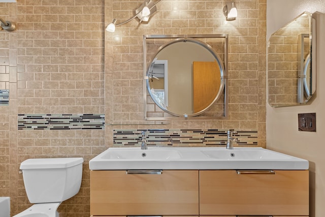 full bathroom with backsplash, tile walls, vanity, and toilet