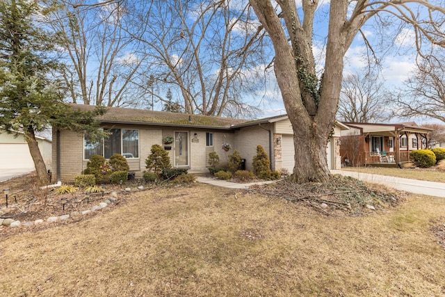 single story home featuring brick siding, an attached garage, concrete driveway, and a porch