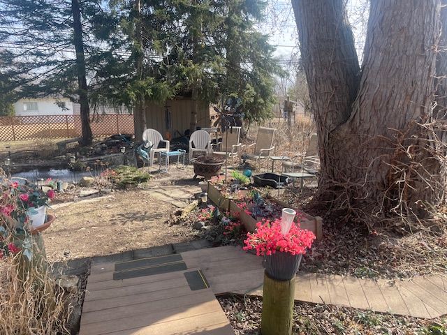 view of yard with an outdoor fire pit and fence