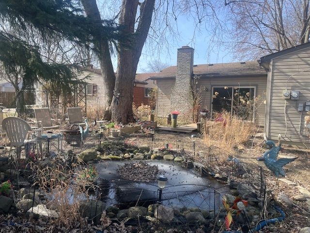 back of house with a chimney