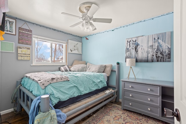 bedroom featuring baseboards and ceiling fan