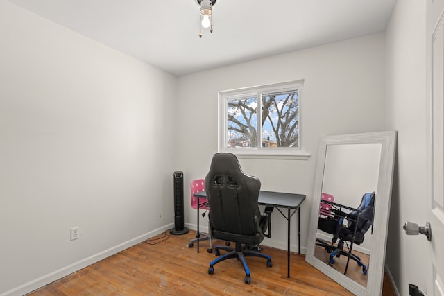 office space with baseboards and wood finished floors