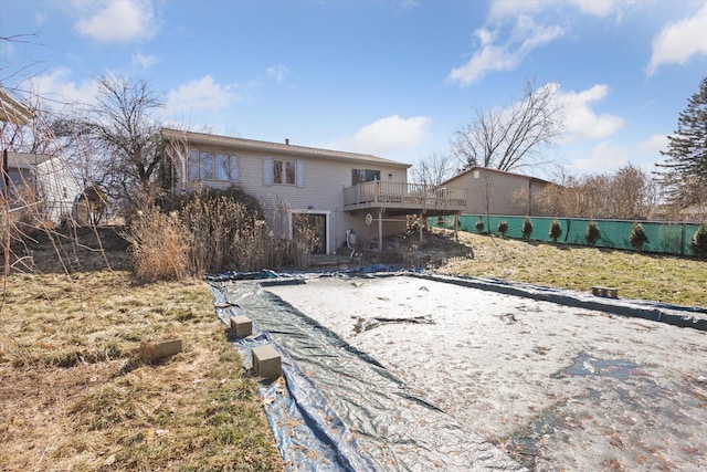 back of house with a deck and fence