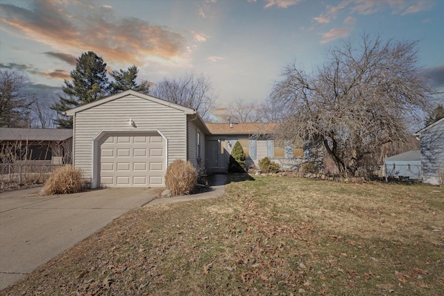 single story home with concrete driveway, a garage, and a front lawn