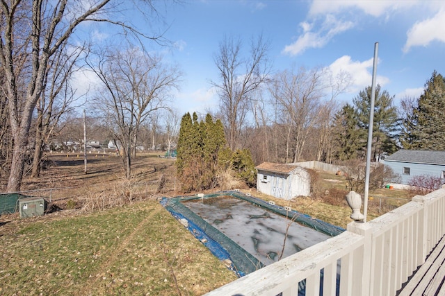 view of yard with a storage unit, an outdoor structure, and fence