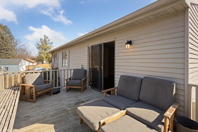 wooden deck featuring an outdoor hangout area and an outdoor structure