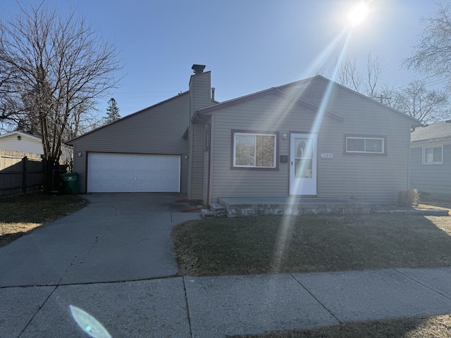 view of front of home featuring concrete driveway, an attached garage, a chimney, and fence