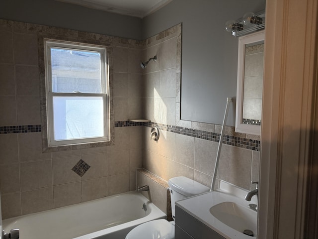 bathroom featuring tile walls, toilet, vanity, and shower / bathing tub combination