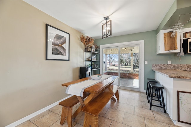 dining space with light tile patterned floors and baseboards