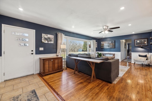 living room with a ceiling fan, recessed lighting, and light wood finished floors