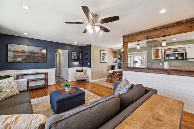 living room with recessed lighting, baseboards, and wood finished floors