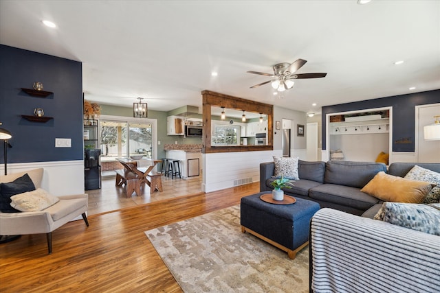 living area featuring visible vents, recessed lighting, a ceiling fan, and light wood-style floors