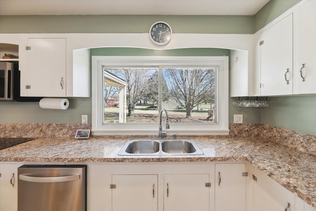 kitchen featuring a sink, light countertops, and white cabinetry