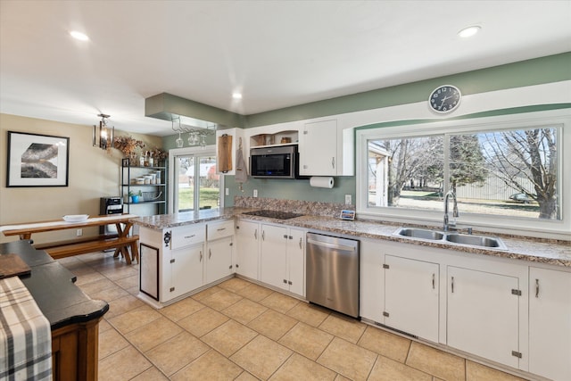 kitchen featuring a sink, recessed lighting, stainless steel appliances, a peninsula, and white cabinets