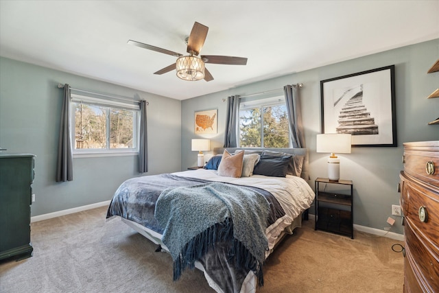 bedroom with baseboards, carpet, and a ceiling fan