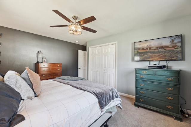 bedroom with a closet, ceiling fan, baseboards, and carpet