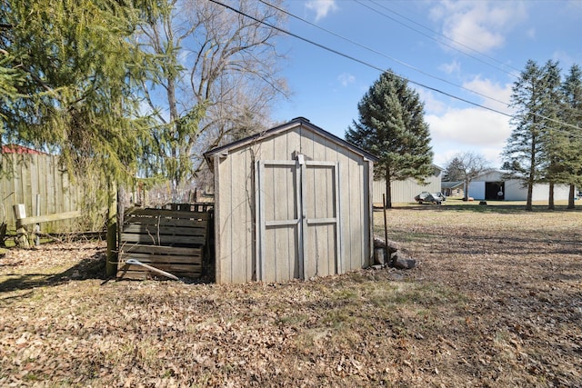 view of shed featuring fence