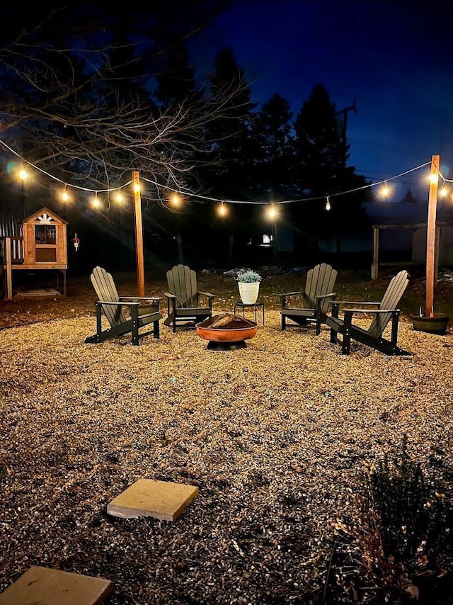 yard at night with an outdoor fire pit