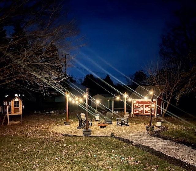 exterior space featuring an outbuilding and an outdoor fire pit