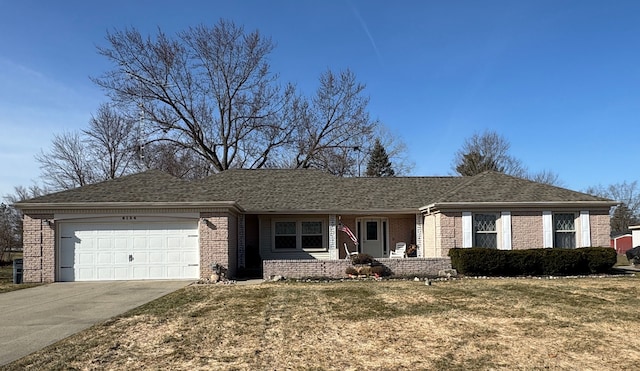 ranch-style home with concrete driveway, an attached garage, brick siding, and a front yard