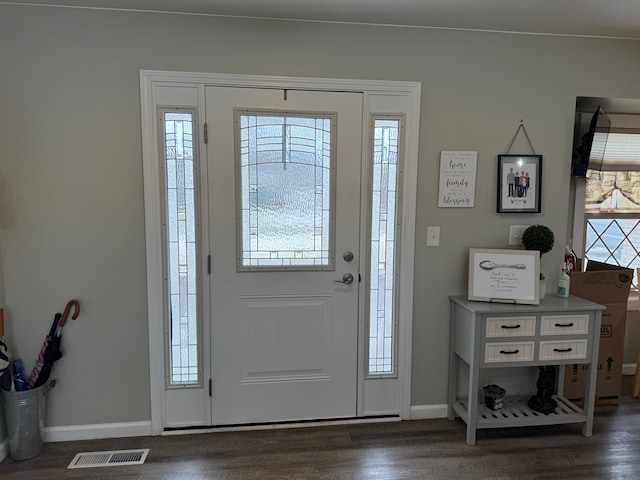 entryway with visible vents, baseboards, and dark wood-style flooring