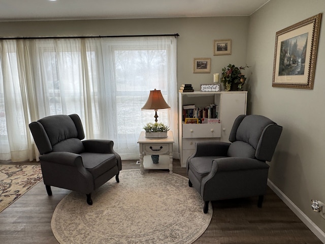 sitting room with wood finished floors and baseboards