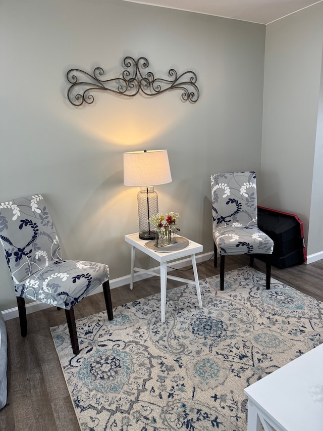 sitting room featuring baseboards and wood finished floors