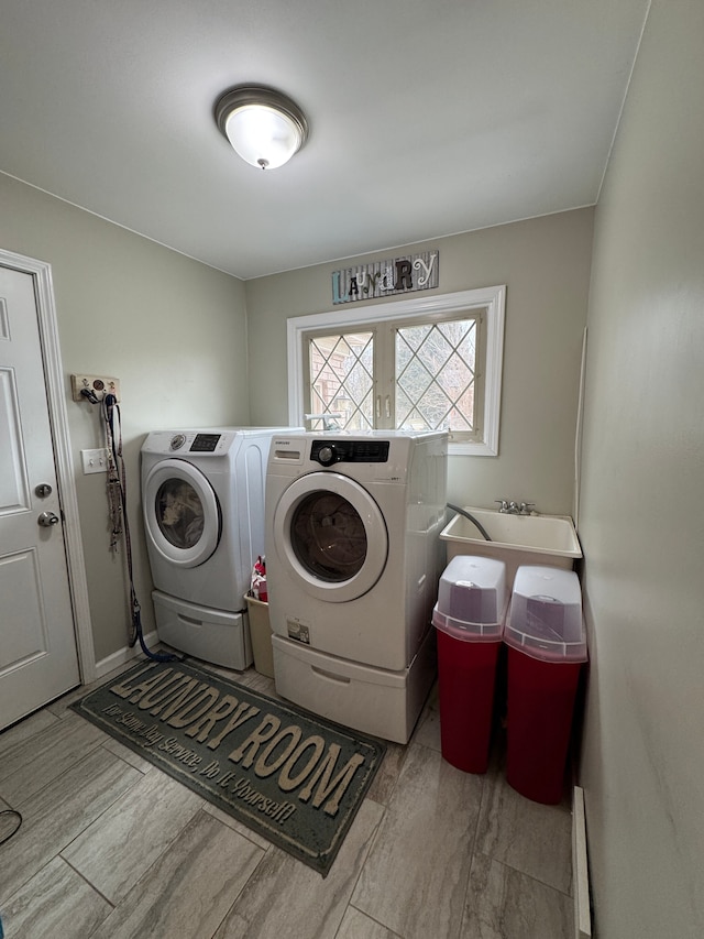 laundry area featuring a sink, wood tiled floor, independent washer and dryer, and laundry area