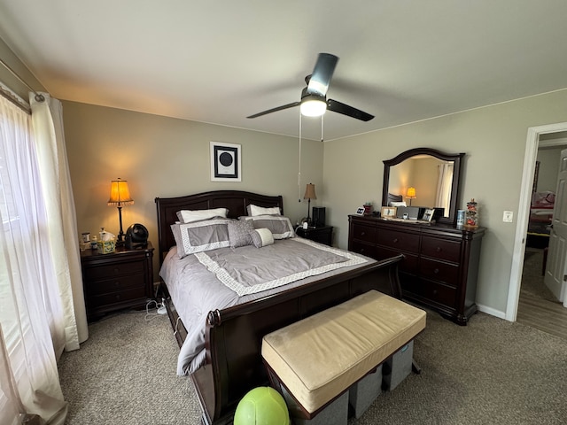 bedroom with ceiling fan, baseboards, and light carpet