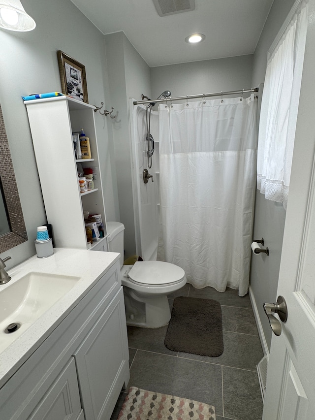 bathroom featuring visible vents, a shower with curtain, toilet, tile patterned flooring, and vanity