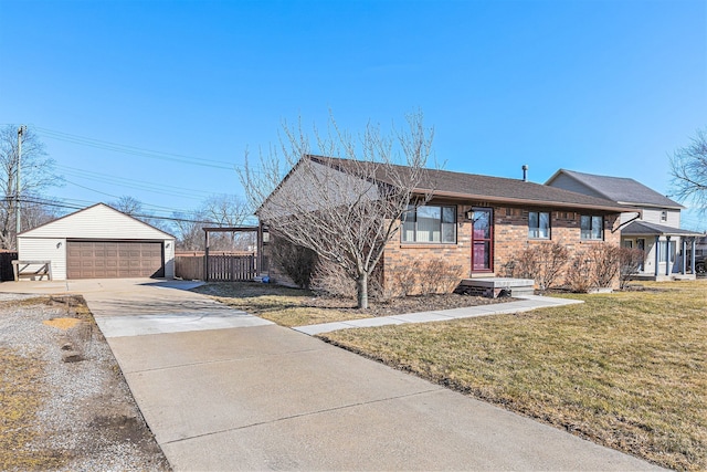 ranch-style home with an outbuilding, a garage, brick siding, and a front lawn