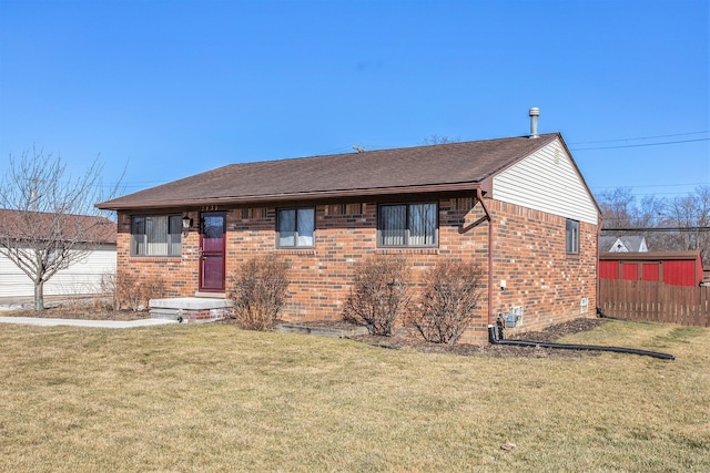 single story home with brick siding, a front yard, and fence