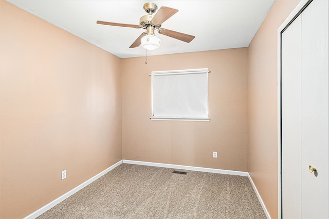 spare room with visible vents, baseboards, ceiling fan, and carpet flooring