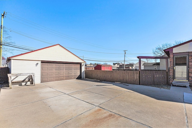 detached garage featuring fence