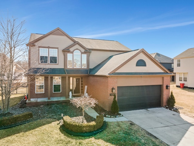 traditional-style home featuring brick siding, an attached garage, and driveway